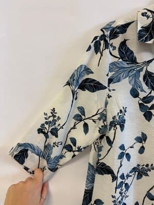 a person cutting a piece of fabric with scissors