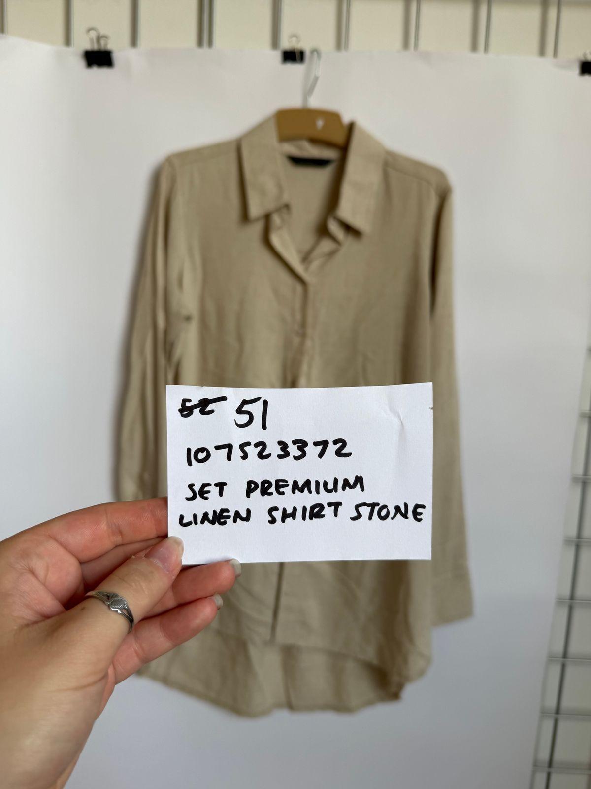 a person holding a piece of paper with a shirt on it