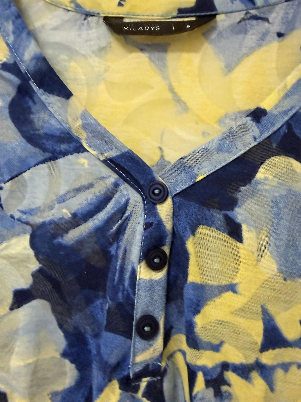 a yellow and blue shirt with a black collar
