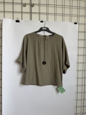 a t - shirt hanging on a hanger on a wall