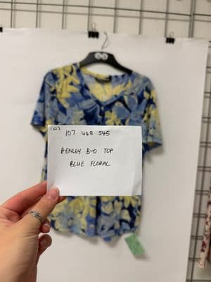 a person holding a piece of paper in front of a shirt