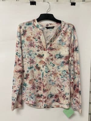 a floral shirt hanging on a hanger