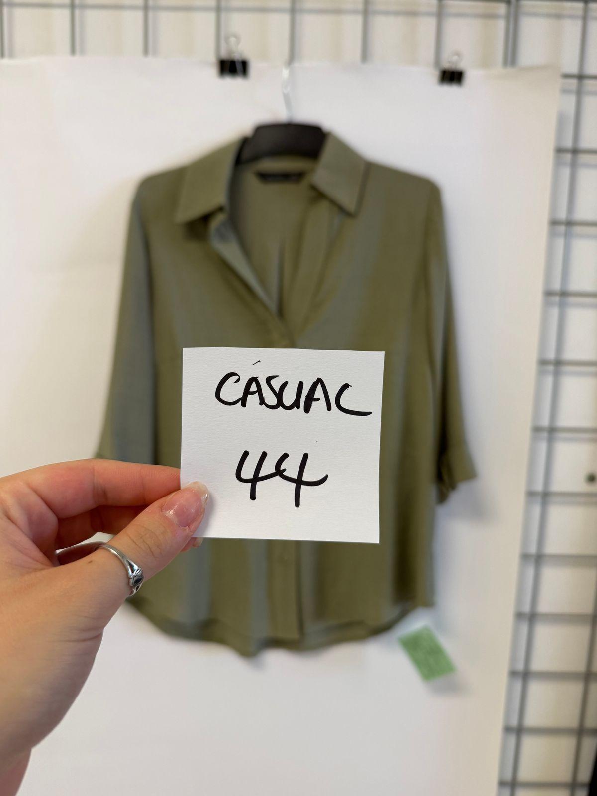 a person holding a piece of paper in front of a shirt