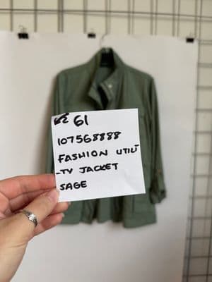 a person holding a piece of paper with a sign on it