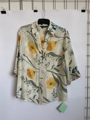 a white shirt with yellow flowers on it