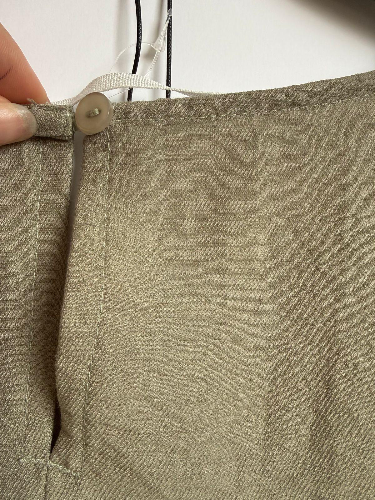 a person is cutting a piece of fabric with a pair of scissors