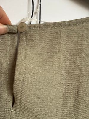 a person is cutting a piece of fabric with a pair of scissors