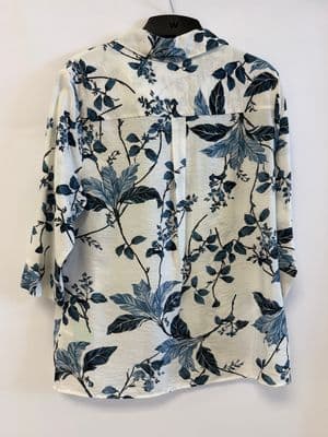 a white shirt with blue leaves on it