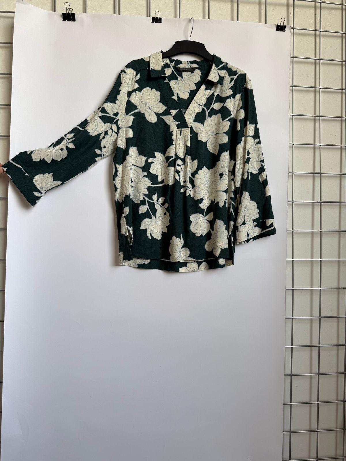 a black and white shirt hanging on a wall