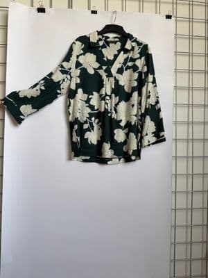 a black and white shirt hanging on a wall