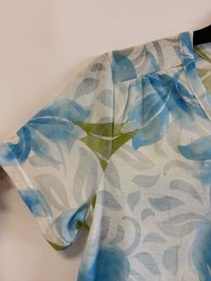 a person cutting a piece of fabric with scissors