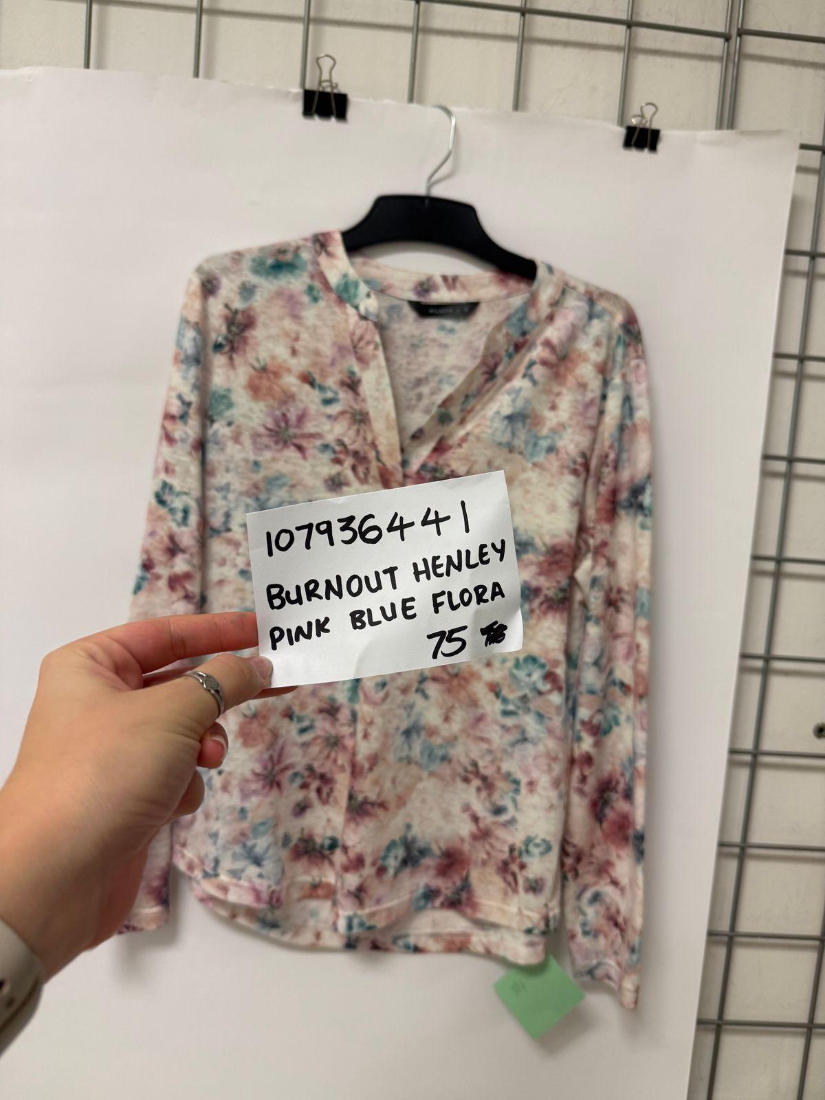 a person holding a piece of paper with a shirt on it