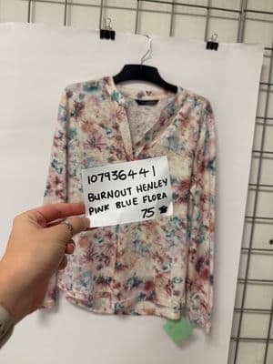 a person holding a piece of paper with a shirt on it