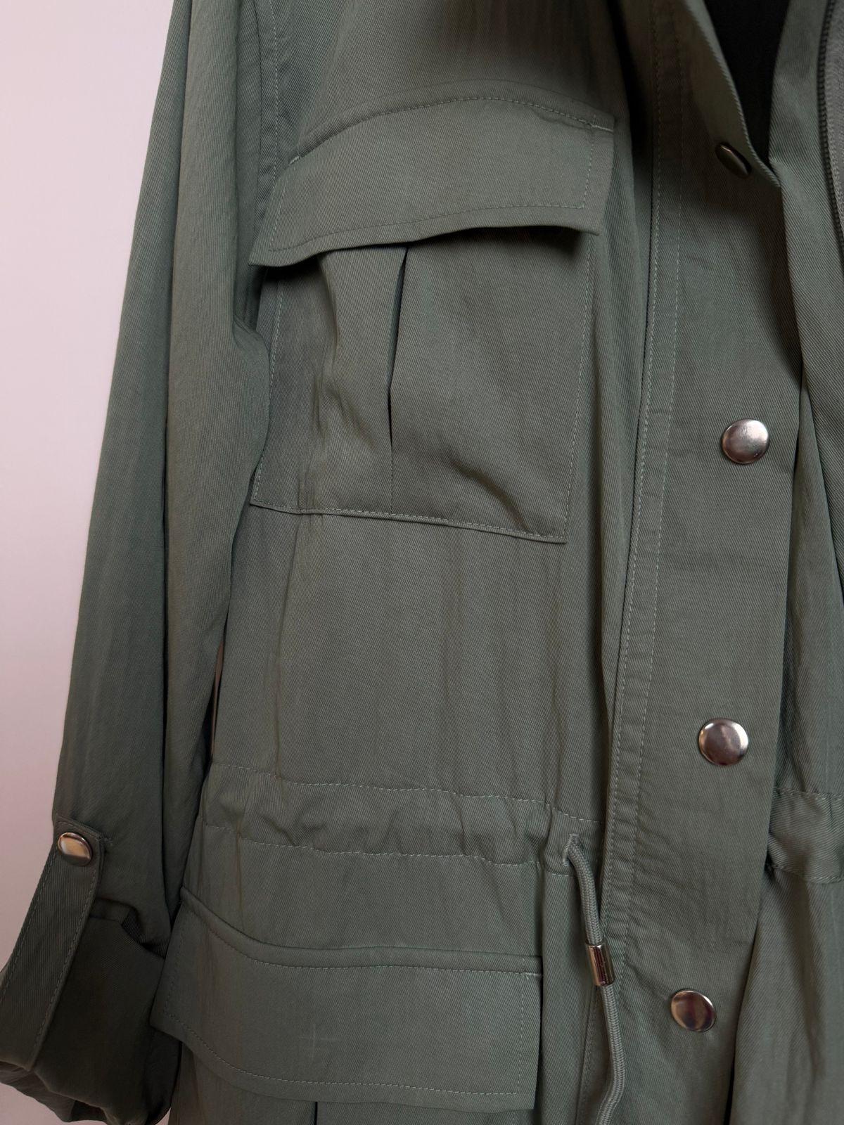a green jacket with a hood and buttons on it