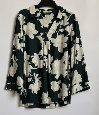a black and white floral shirt hanging on a wall