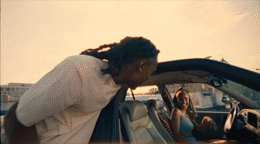 a man with dreadlocks sitting in a car