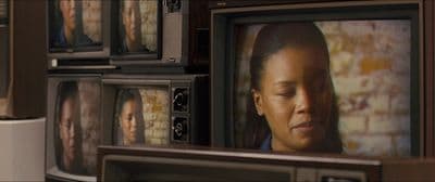 a wall of televisions with a woman's face on them
