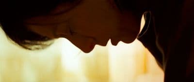 a close up of a woman's face with her eyes closed