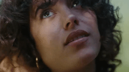 a close up of a woman with curly hair