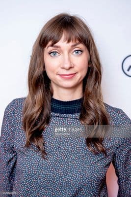 a woman in a blue dress poses for a photo
