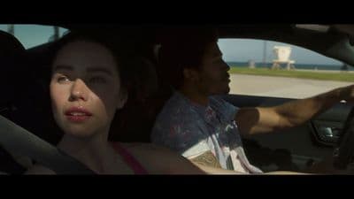 a man driving a car next to a woman