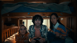 a group of people sitting on top of a bunk bed