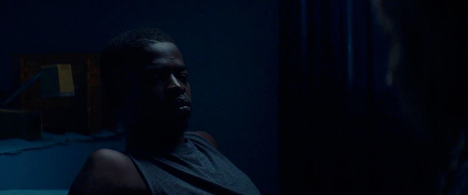 a man in a dark room with a mirror