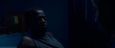 a man in a dark room with a mirror