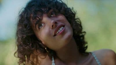 a close up of a person with curly hair