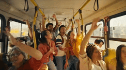 a group of people holding up their hands in the air
