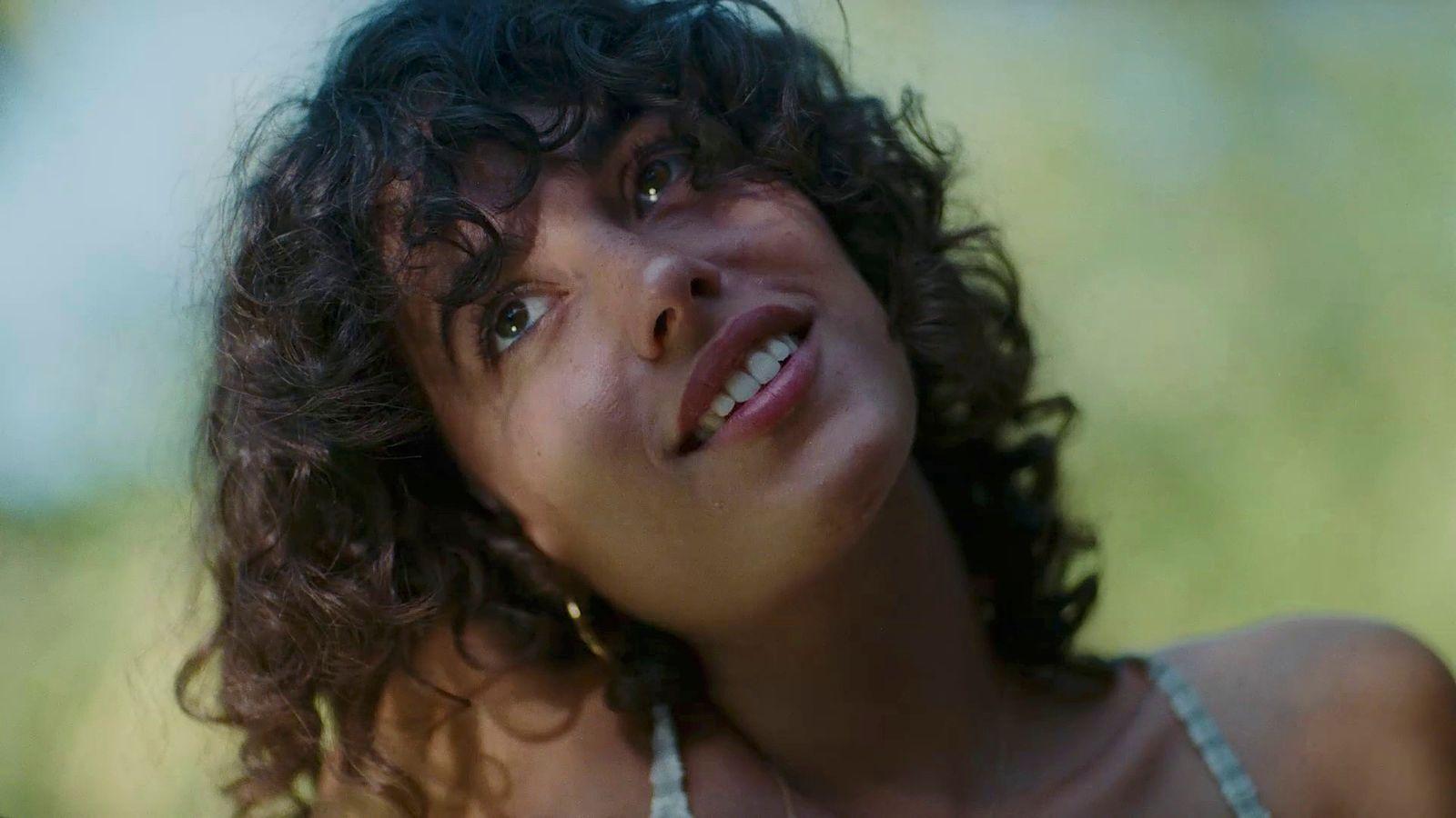 a close up of a person with curly hair
