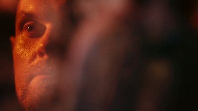 a close up of a man's face with a blurry background