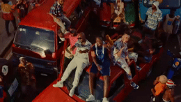 a group of people riding on the back of a red truck