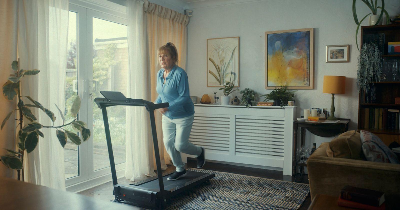 a woman on a treadmill in a living room