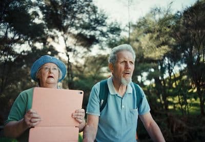 a man and a woman holding a pink sign