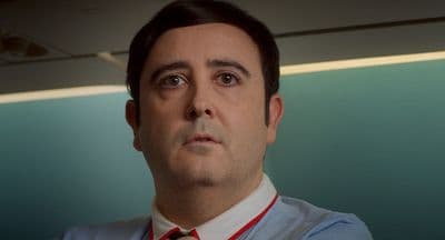 a man wearing a tie and a blue shirt