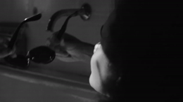 a woman washing her hands in a sink