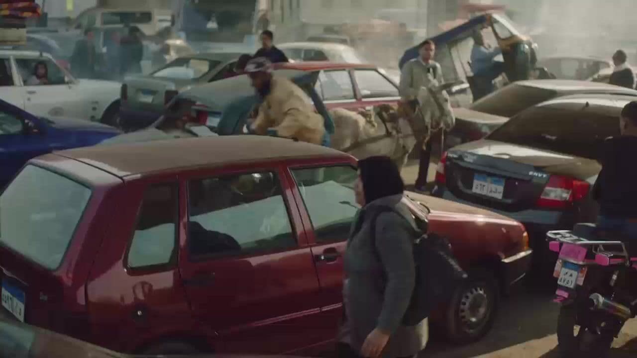 a busy street filled with lots of cars and motorcycles
