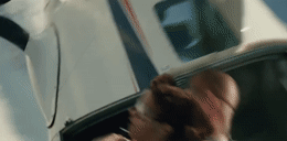 a blurry image of a man in a car