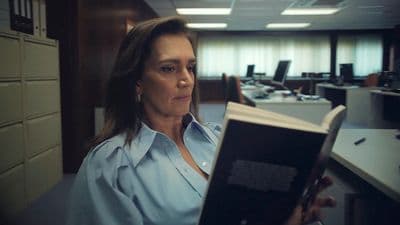 a woman reading a book in an office