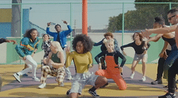 a group of young people dancing on a basketball court
