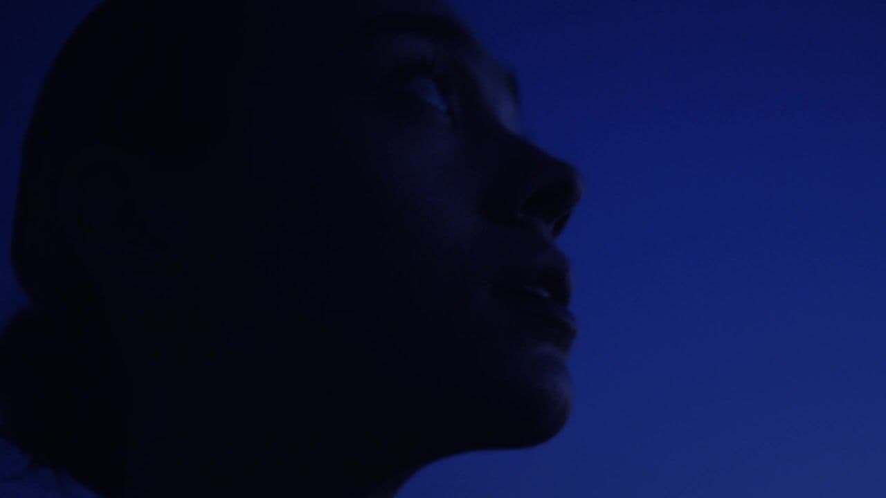 a close up of a person's face in the dark