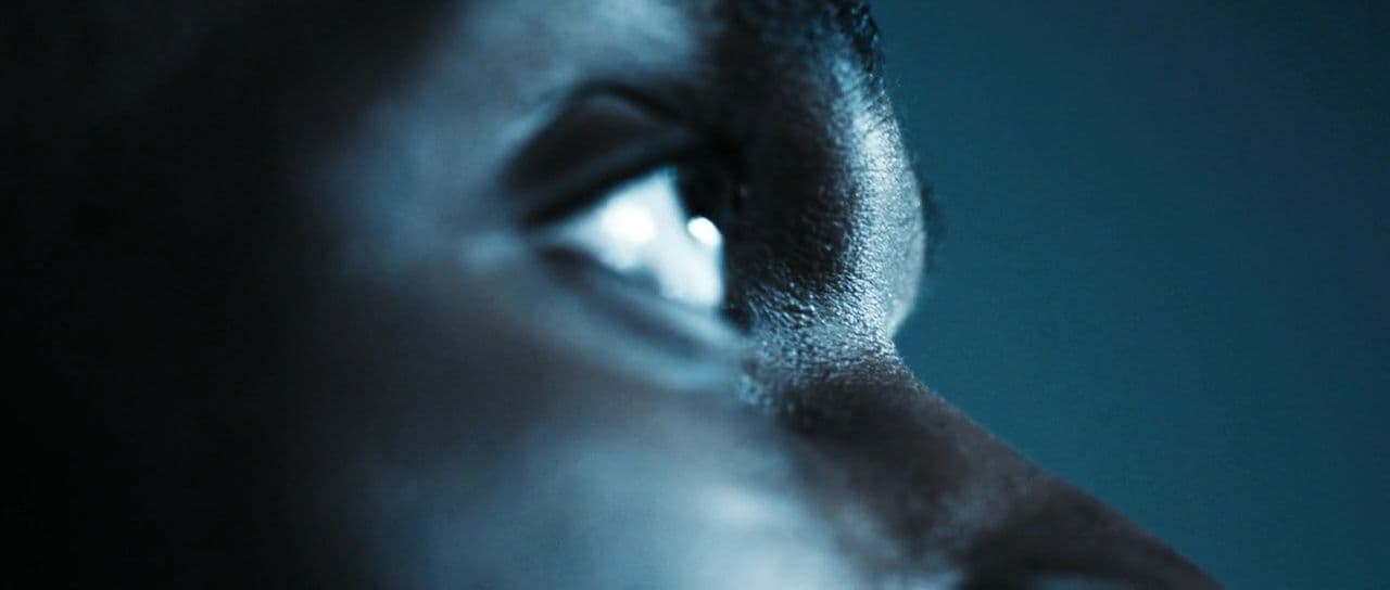 a close up of a person's face with a blue background
