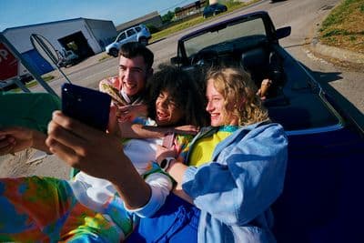 a group of people sitting in the back of a car