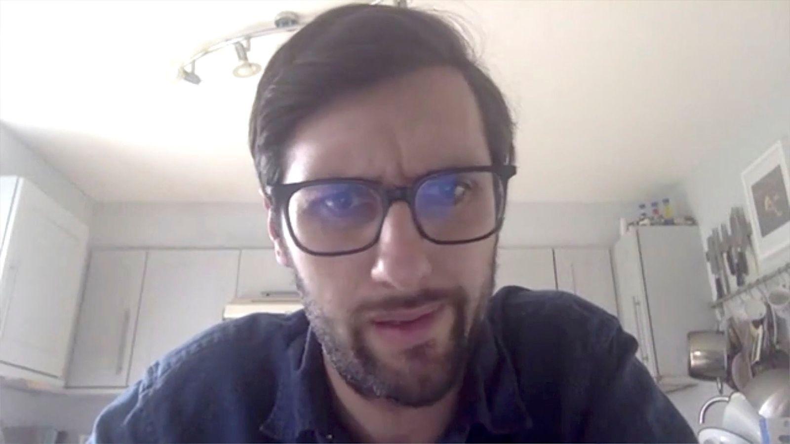 a man with glasses making a funny face
