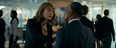 a woman talking to a man in a suit