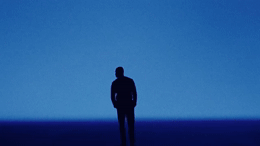 a man standing in the middle of a dark room