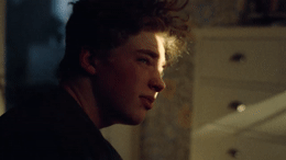 a close up of a person with curly hair