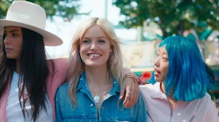 a group of women with blue hair standing next to each other