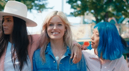 a group of women with blue hair standing next to each other